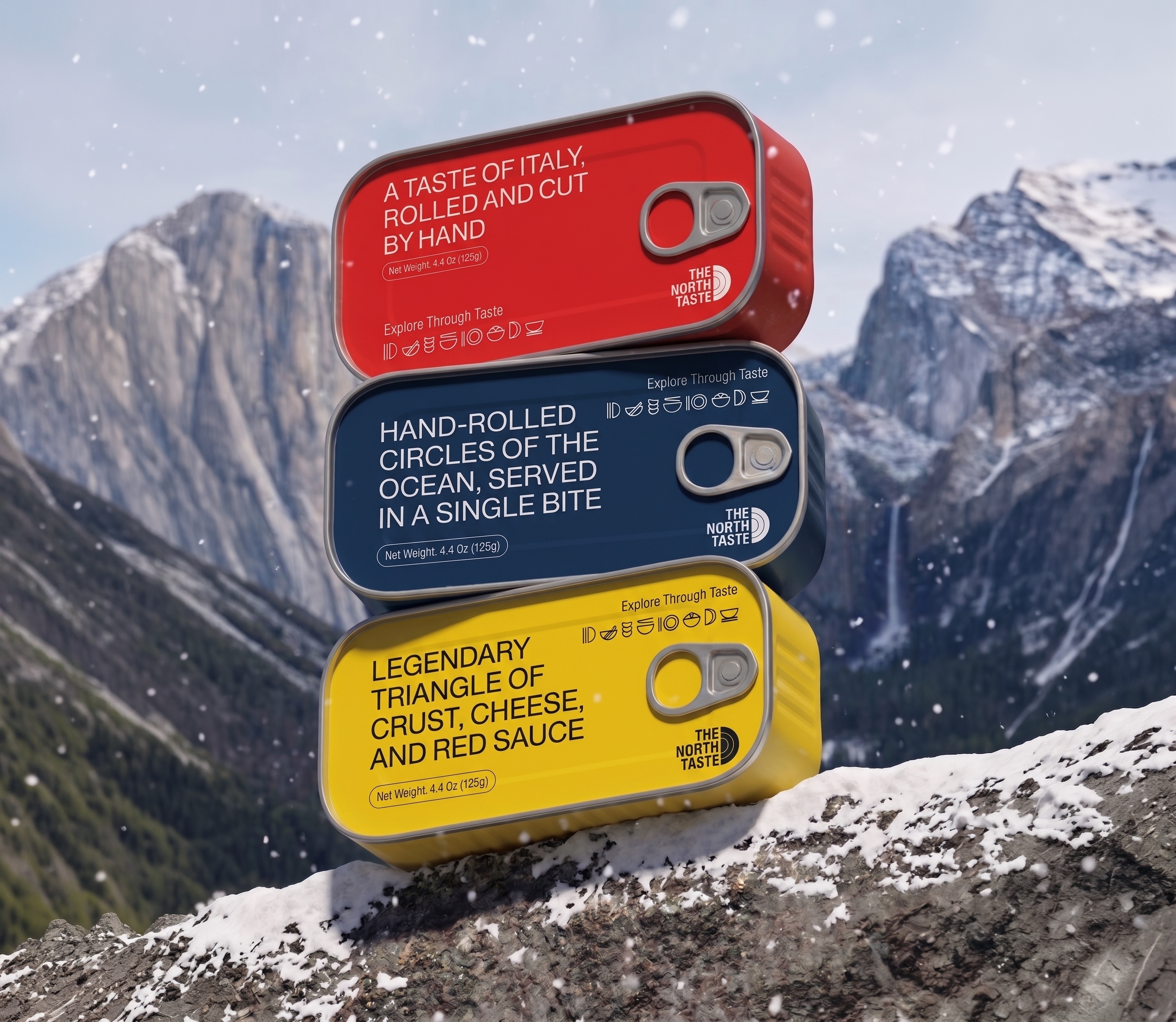 Three North Taste canned goods (red, navy, and yellow) resting on snowy mountain rocks